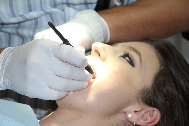 A girl during dental scaling and root planing