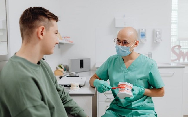 Dentist educating patient 