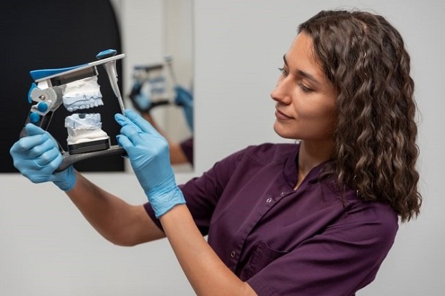 dentist holding a impression of prepared teeth